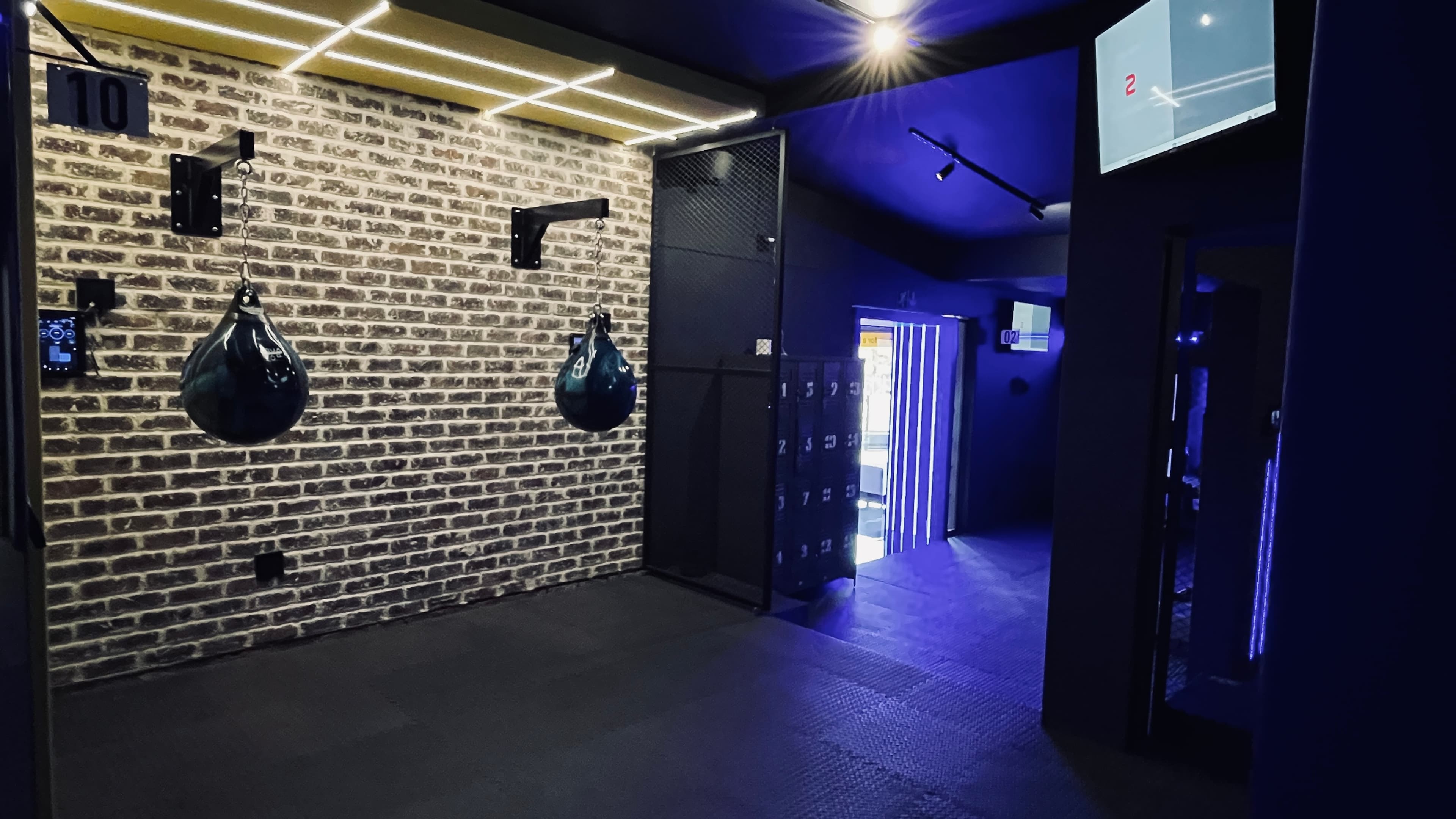 Aqua bag boxing stations along the brick wall at TENROUNDS Pretoria East