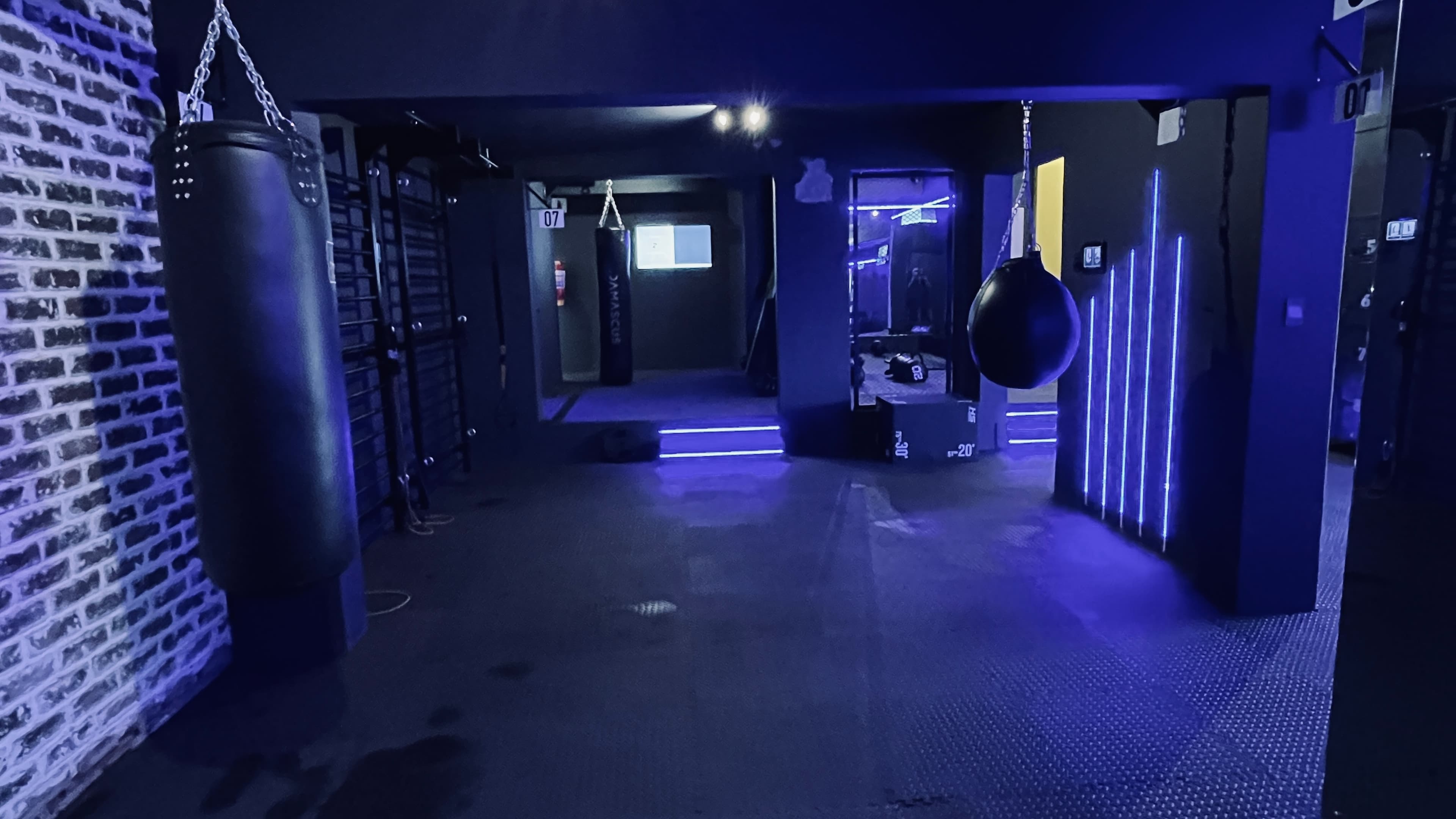 Corridor of numbered boxing stations at TENROUNDS Garsfontein