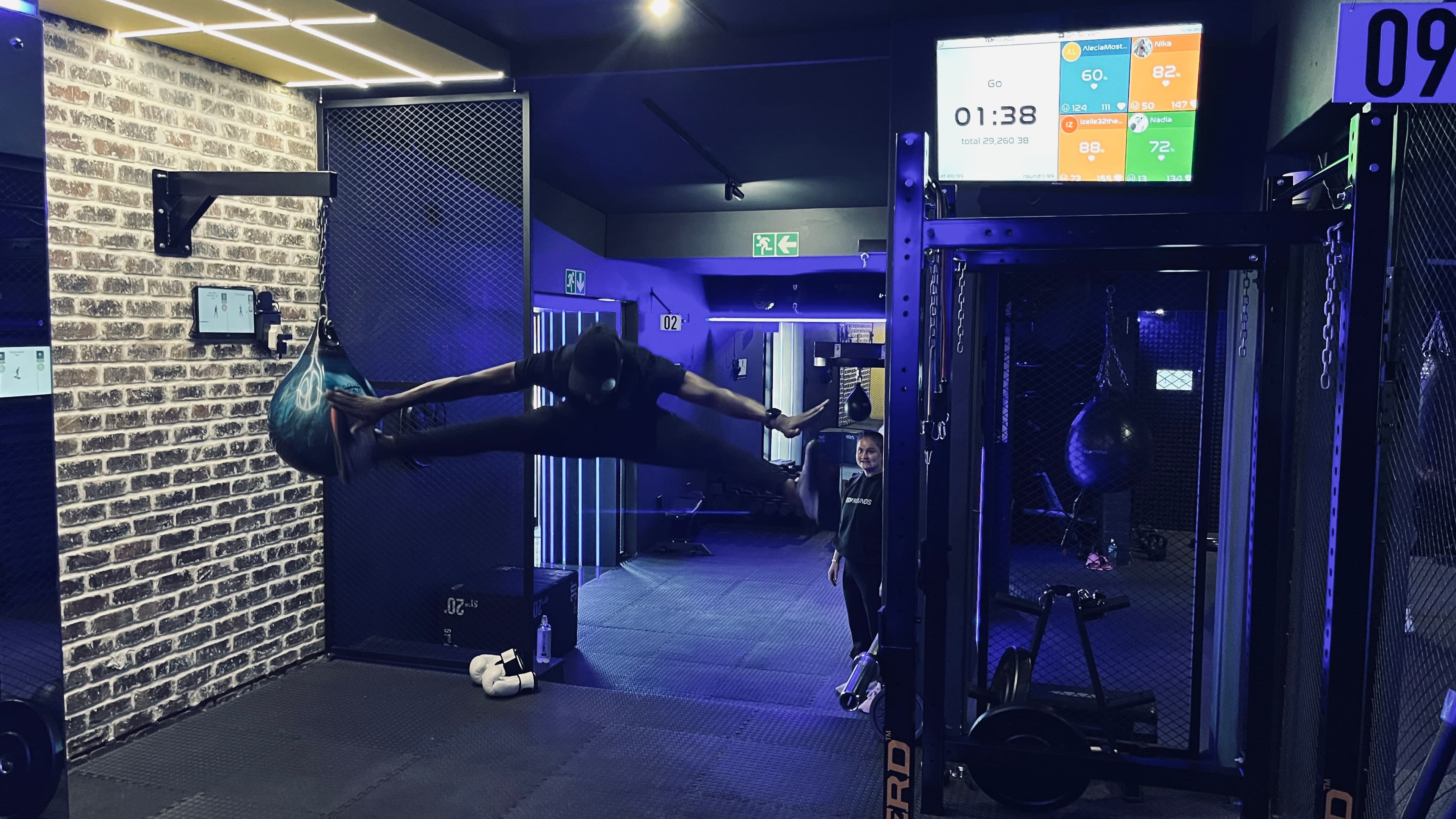 Member mid-air during an intense boxing workout at TENROUNDS Garsfontein