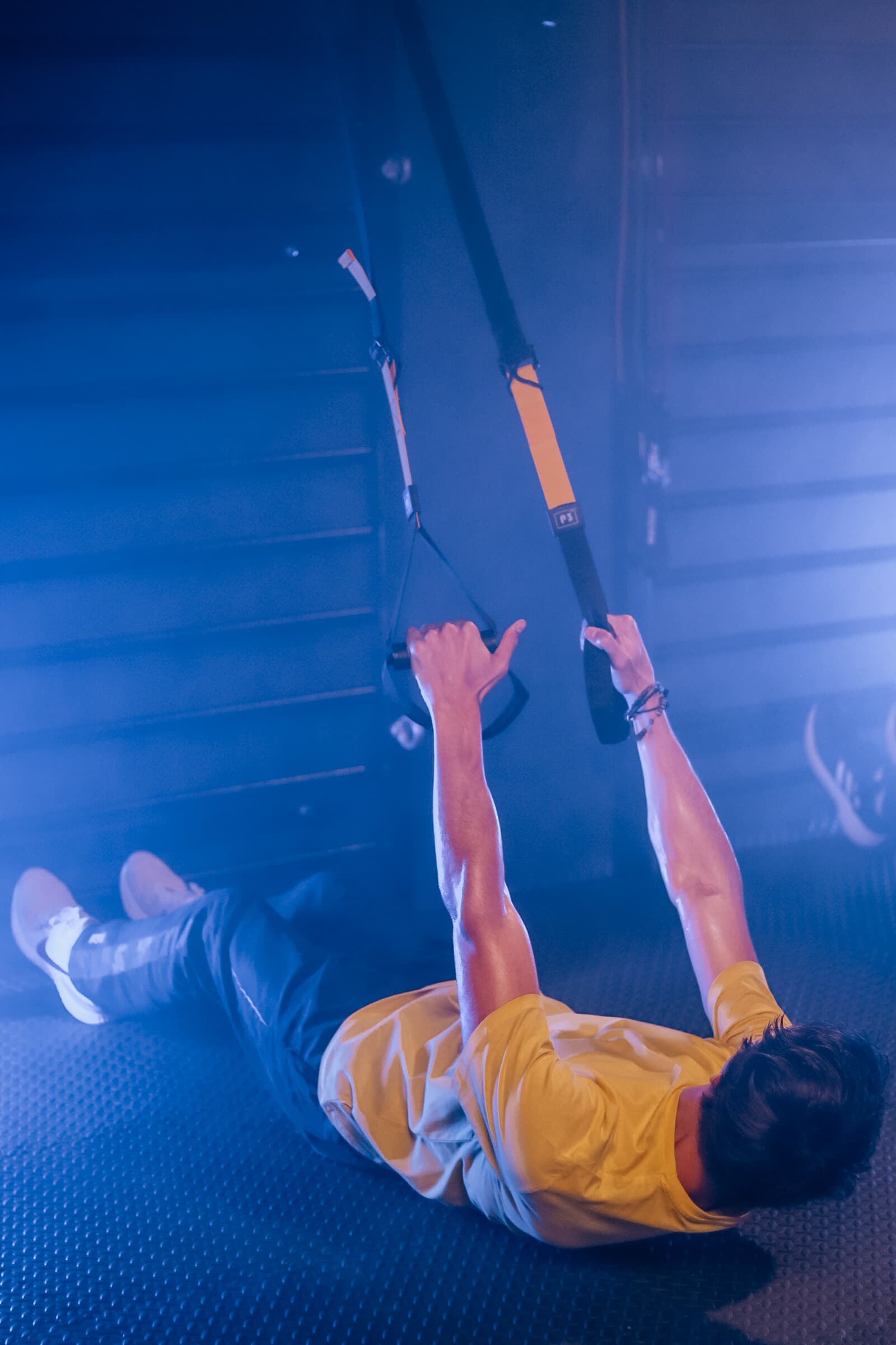 Member performing suspension TRX rows during a TENROUNDS HIIT workout