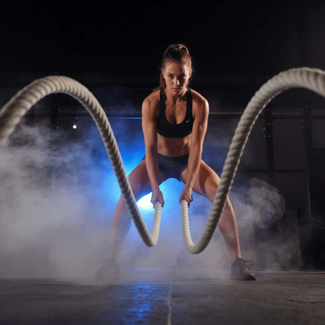Athlete training with battle ropes